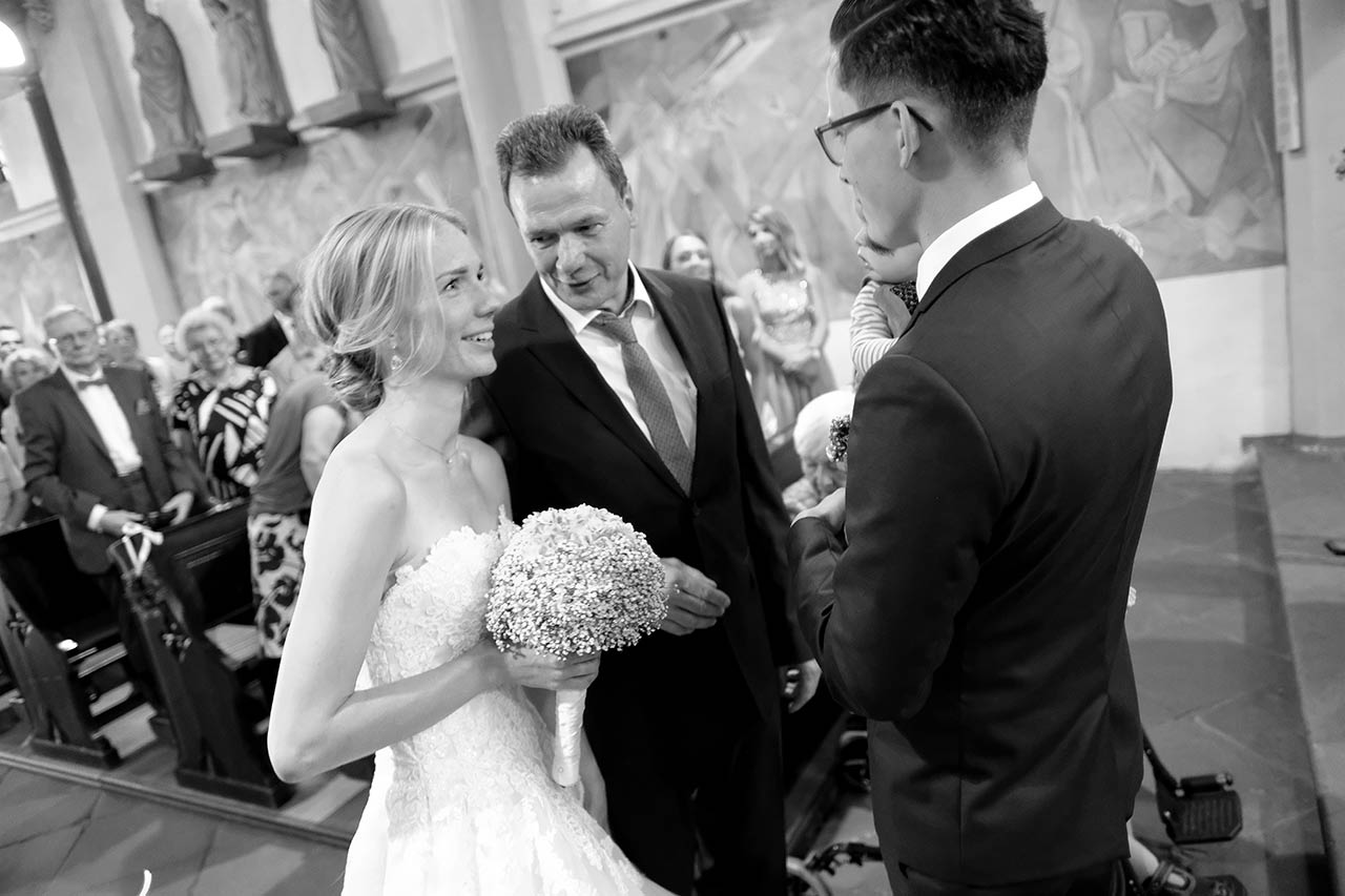 Hochzeitspaar jubelt im Cabriolet